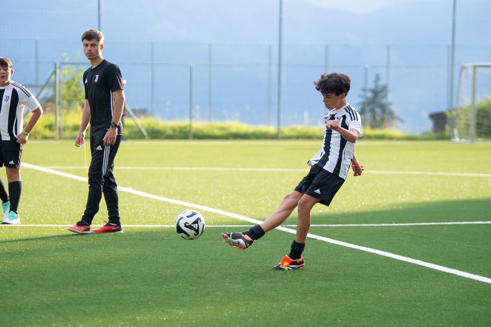 Students playing football during Juventus training session