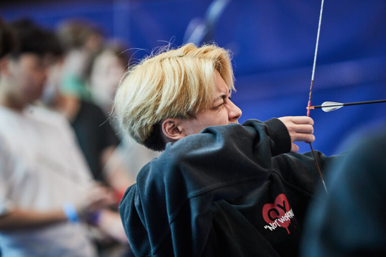 Students practicing archery during summer camp