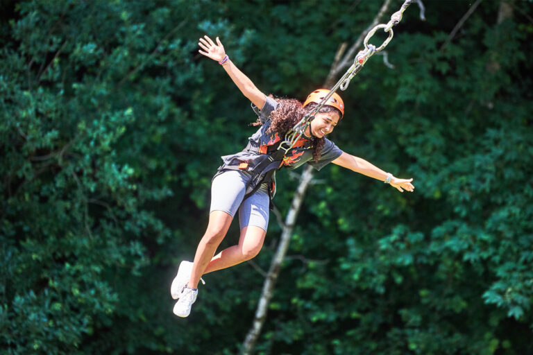Students jumping from bridge during adventure activity