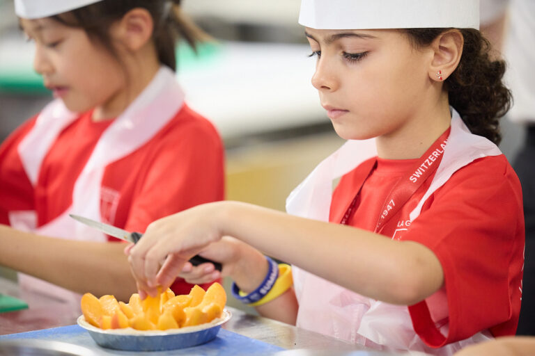 Students cooking during summer camp workshop