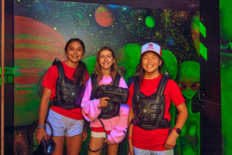 Students playing laser game during summer camp