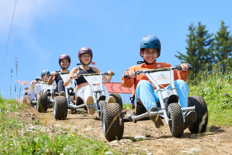 Students riding mountain carts during summer camp