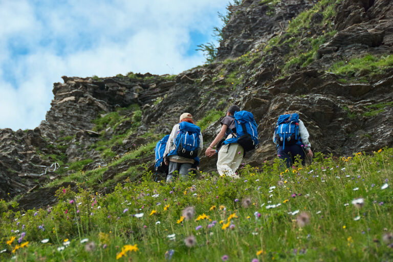 Students hiking during mountain expedition at summer camp