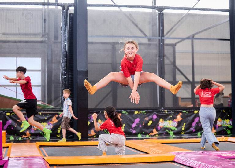 Students jumping on trampoline during summer camp