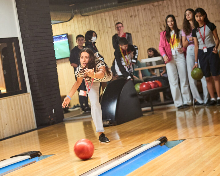 Students bowling during summer camp activity