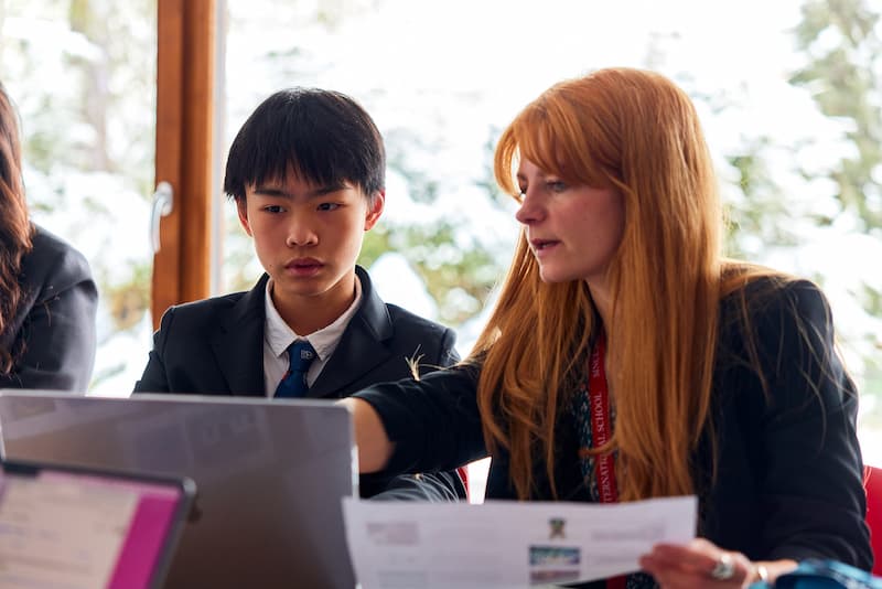 A La Garenne Primary student receiving individual support from a teacher during a lesson.