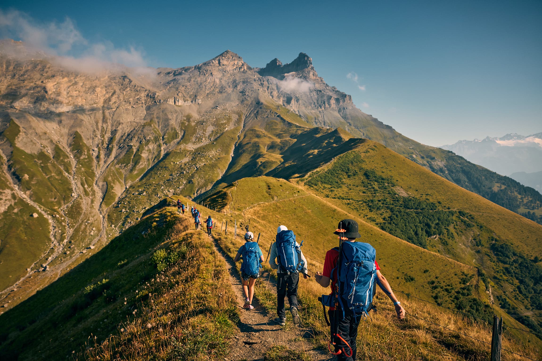 Students hiking along alpine trails during La Garenne Summer Camp outdoor adventure programme