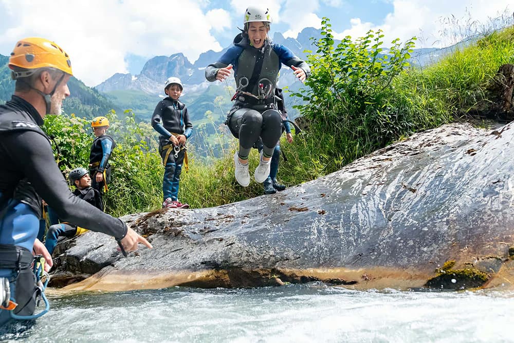 Students canyoning during outdoor summer camp activity