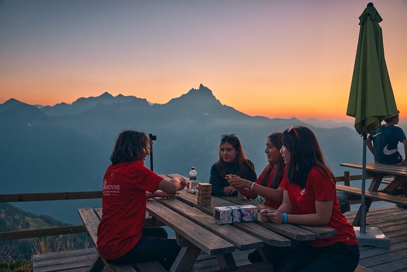 A group of La Garenne High School students enjoying the sunset and a snack during a High School expedition.